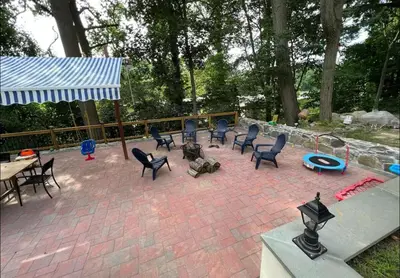 a patio with chairs and a table and a group at Ultra Contemporary Loft in Scarsdale