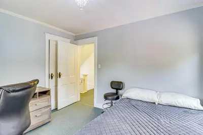 a bedroom with a bed and a desk and a chair at Walkable Abode in Stroudsburgs Business District! in Stroudsburg