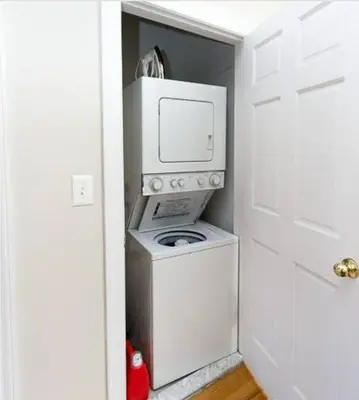 a washer and dryer in a small room at private spacious apartment with 2 bedrooms 2 bathroomss and a deck in New York