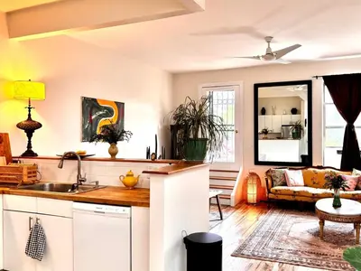 a kitchen and living room with a couch at private spacious apartment with 2 bedrooms 2 bathroomss and a deck in New York