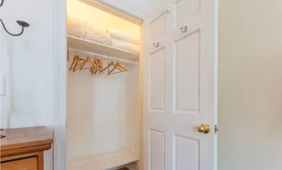 a closet with a white door and a rack of shoes at private spacious apartment with 2 bedrooms 2 bathroomss and a deck in New York