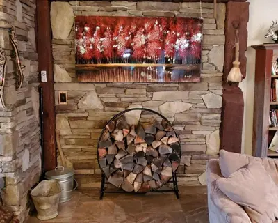 a fireplace with a pile of fire wood at Serendipity Lake House in Windham