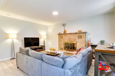 a living room with a blue couch and a fireplace at Walk to Lake Carobeth Gem in Pocono Country Place in Tobyhanna