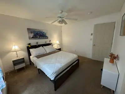 a bedroom with a bed and a ceiling fan at Joy Cabin Where Family Friends Make Memories in Long Pond
