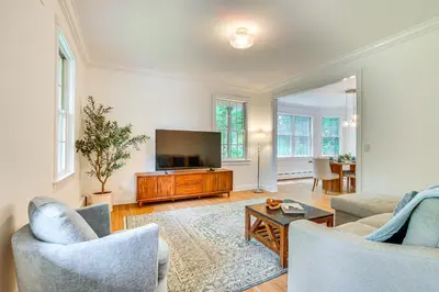 a living room with two chairs and a television at Serene Hudson Valley Escape with Pool and Grill in Carmel