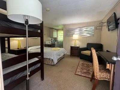 a bedroom with a bunk bed and a desk at West Wind Motel in Fleischmanns
