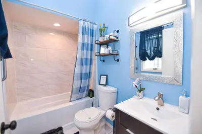 a bathroom with a tub and a toilet and a sink at Bool Bear Lodge a pet friendly Pocono Vacation Home with Fireplace, BBQ and more in Tobyhanna