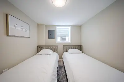 two beds in a small room with a window at Harmony House in Liberty