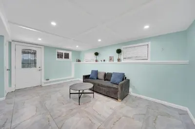 a living room with a couch and a stool at Harmony House in Liberty