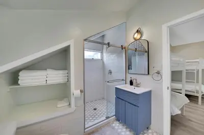 a bathroom with a shower and a sink and a bunk bed at Harmony House in Liberty