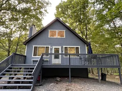 a tiny house with a porch and stairs at Masthope Retreat in Lackawaxen