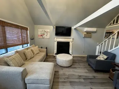 a living room with a couch and a fireplace at Masthope Retreat in Lackawaxen