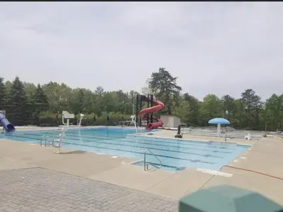 a large swimming pool with a slide and a playground at Masthope Retreat in Lackawaxen