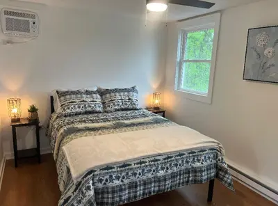 a bedroom with a bed with pillows and a window at Adirondack Home #8 in Hamilton
