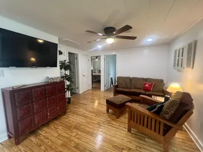 a living room with a couch and a ceiling fan at Adirondack Home #8 in Hamilton