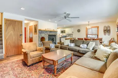a living room with a couch and a table at 3 min to Mt Snow with FREE Shuttle! Family-Size fun, Wood fireplace, 2 living rooms, Arcades in Dover