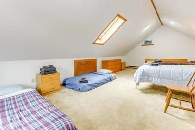 a attic bedroom with two beds and a skylight at 3 min to Mt Snow with FREE Shuttle! Family-Size fun, Wood fireplace, 2 living rooms, Arcades in Dover