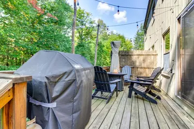 a tent on a deck with chairs and a table at 3 min to Mt Snow with FREE Shuttle! Family-Size fun, Wood fireplace, 2 living rooms, Arcades in Dover