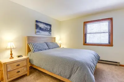 a bedroom with a large bed and a window at 3 min to Mt Snow with FREE Shuttle! Family-Size fun, Wood fireplace, 2 living rooms, Arcades in Dover