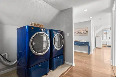 two blue washing machines in a laundry room at Beachfront Apartment - 8 min from downtown in New Haven