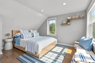 a bedroom with a bed and a couch at Beachfront Apartment - 8 min from downtown in New Haven
