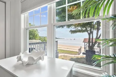 a room with a window with a view of the beach at Beachfront Apartment - 8 min from downtown in New Haven