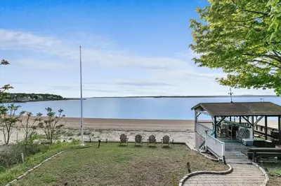 a view of a beach with a gazebo at Beachfront Apartment - 8 min from downtown in New Haven