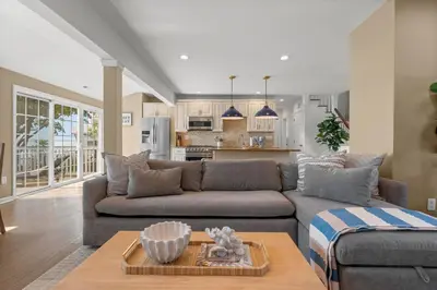 a living room with a couch and a table at Beachfront Apartment - 8 min from downtown in New Haven