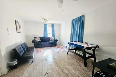 a living room with a ping pong table in it at Explore Poconos with Fire pit, Games, Grill in Tobyhanna