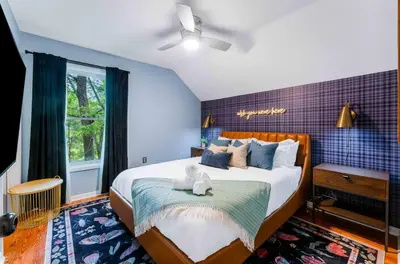 a bedroom with a large bed and a window at Dine Outdoors, Dream Indoors 5BR in East Stroudsburg