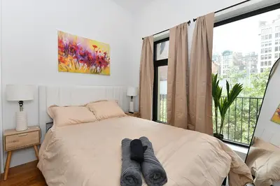 a bedroom with a bed with socks on it at Boho Rustic Escape with Masssive Terrace in Midtown in New York