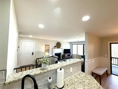 a kitchen and living room with a counter top at The Canopy 4BR Forest Escape Spa, Sip, and Unwind in Vernon Township