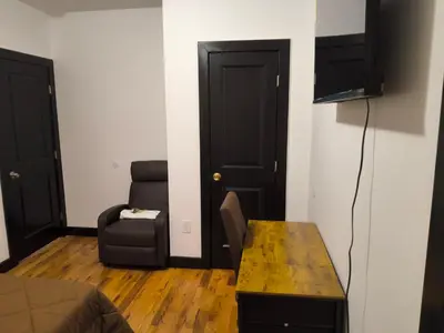 a small living room with a couch and a chair at Log Comfort in Newark