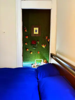 a bedroom with a blue bed and a green wall at Nintendo, Filtered H2O, Cafe, Central, Self-Check in Troy