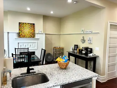 a kitchen with a sink and a counter top at Nintendo, Filtered H2O, Cafe, Central, Self-Check in Troy