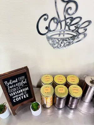 a table with five jars of food next to a sign at Nintendo, Filtered H2O, Cafe, Central, Self-Check in Troy
