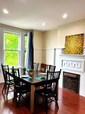 a dining room with a table and chairs and a fireplace at Nintendo, Filtered H2O, Cafe, Central, Self-Check in Troy