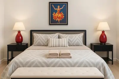 a bed with two lamps and two towels on it at Group-Friendly Luxury 3BR 2 Baths Sleeps 8 in Irvington