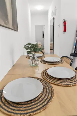 a table with two white plates on top of it at Style & Comfort 3 Rooms 15 min from NYC in West New York