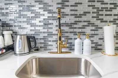 a kitchen counter with a sink with a sink at Style & Comfort 3 Rooms 15 min from NYC in West New York