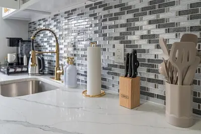 a kitchen counter with a sink and a brick wall at Style & Comfort 3 Rooms 15 min from NYC in West New York