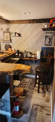 a room with a table and a chair and wooden floors at Getaway at the Hideout in Lake Ariel