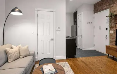 a living room with a couch and a table at Stylish Retreat in Prime West Village Spot in New York