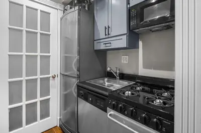 a kitchen with a stove and a refrigerator at Trendy East Village Escape in New York