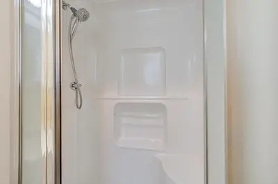 a shower door with two shelves in a bathroom at 1 Mi to Hunter Mtn Cozy Unit on 6-Acre Property! in Hunter