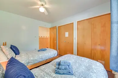 a bedroom with two beds and wooden cabinets at 1 Mi to Hunter Mtn Cozy Unit on 6-Acre Property! in Hunter