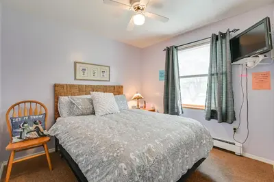 a bedroom with a bed and a flat screen tv at 1 Mi to Hunter Mtn Cozy Unit on 6-Acre Property! in Hunter