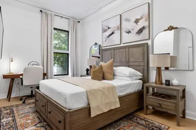 a bedroom with a bed and a desk in it at 2BR and 2BA in Historic Brownstone near Subway in New York