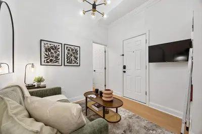 a living room with a couch and a table at 2BR and 2BA in Historic Brownstone near Subway in New York