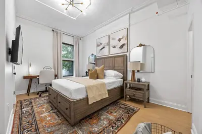 a bedroom with a bed and a desk in it at 2BR and 2BA in Historic Brownstone near Subway in New York